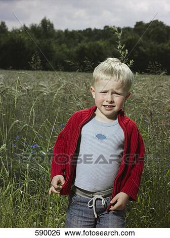 A boy frowning in a wheat field View Large Photo Image Stock Photograph - A boy frowning in a wheat field. Fotosearch