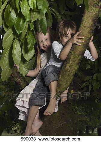 Stock Image - Two children sitting in a tree. Fotosearch