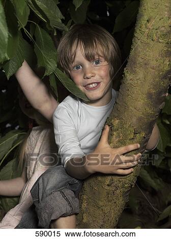 Two children sitting in a tree View Large Photo Image Stock Photography - Two children sitting in a tree. Fotosearch
