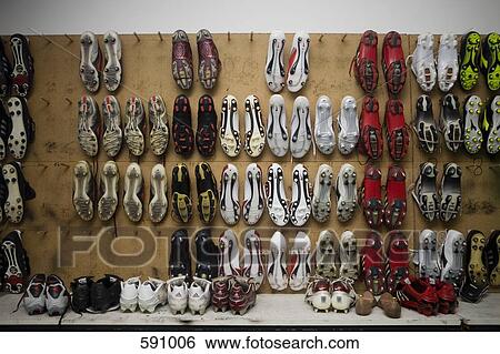 Stock Photograph - Football boots hanging on a wall. Fotosearch