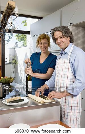 A couple preparing dinner in the kitchen View Large Photo Image Stock Image - A couple preparing dinner in the kitchen. Fotosearch