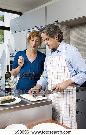 Stock Photograph -  A couple preparing sushi. Fotosearch