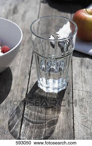 A glass of water on a table View Large Photo Image Stock Image - A glass of water on a table. Fotosearch