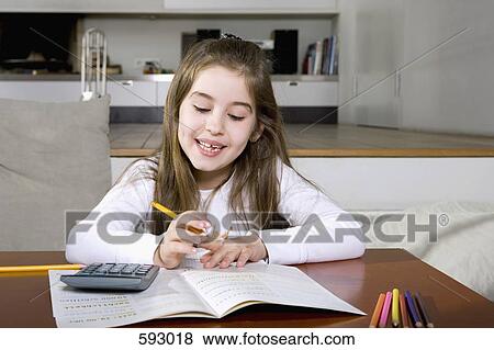 A little girl doing her homework View Large Photo Image Stock Photo - A little girl doing her homework. Fotosearch