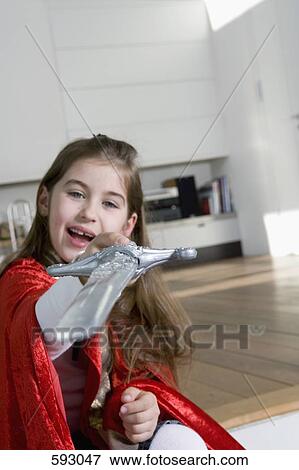 A little girl holding a toy sword View Large Photo Image Stock Photo - A little girl holding a toy sword. Fotosearch