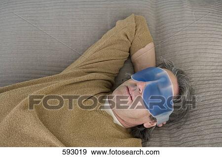 A man relaxing with an eye mask View Large Photo Image Stock Photo - A man relaxing with an eye mask. Fotosearch
