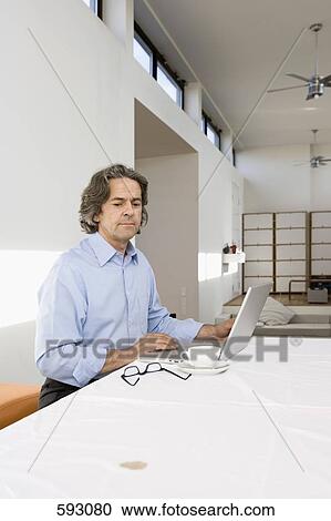 A man working from home View Large Photo Image Stock Image - A man working from home. Fotosearch