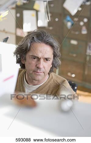 A man working in his study View Large Photo Image Stock Photo - A man working in his study. Fotosearch