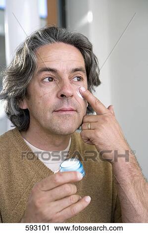 A mature man applying moisturizer to his face View Large Photo Image Stock Image - A mature man applying moisturizer to his face. Fotosearch