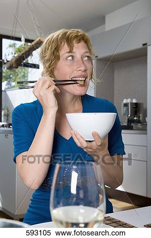 A woman eating stir-fry View Large Photo Image Stock Photography - A woman eating stir-fry. Fotosearch
