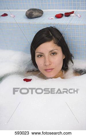 Stock Image - A woman having a bath. Fotosearch