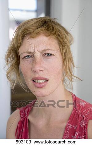 Stock Image - A woman looking annoyed. Fotosearch