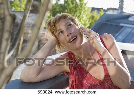 A woman on her mobile phone View Large Photo Image Picture - A woman on her mobile phone. Fotosearch