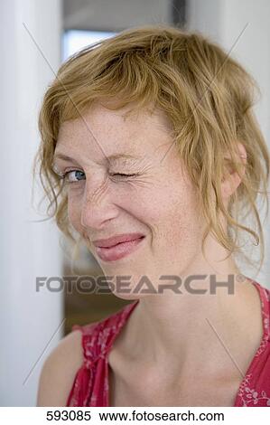 A woman winking View Large Photo Image Stock Photography - A woman winking. Fotosearch