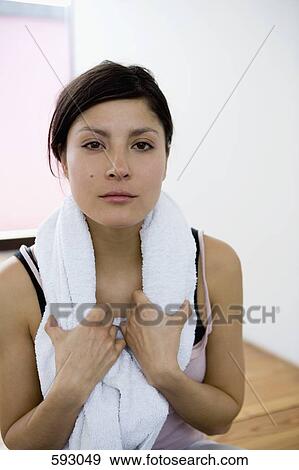 A woman with a towel around her neck View Large Photo Image Stock Photo - A woman with a towel around her neck. Fotosearch