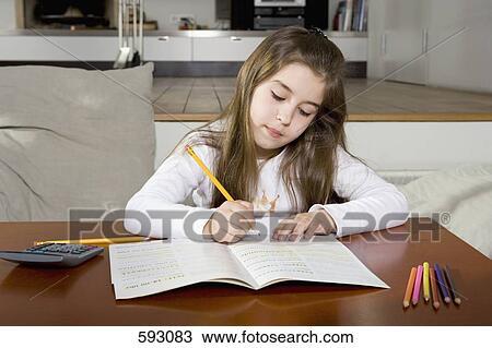 A young girl doing homework View Large Photo Image Stock Image - A young girl doing homework. Fotosearch