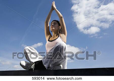 A young woman practicing yoga View Large Photo Image Picture - A young woman practicing yoga. Fotosearch