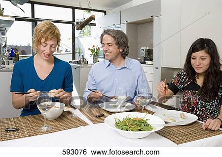 Friends having dinner together View Large Photo Image Stock Photograph - Friends having dinner together. Fotosearch