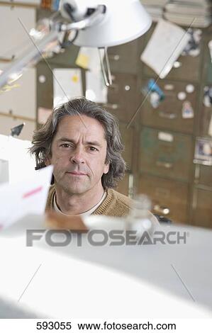 Stock Photography - Man sitting in his study. Fotosearch