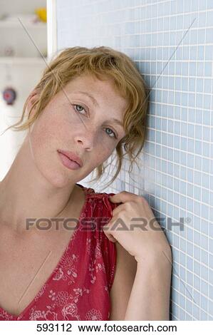 Portrait of a woman leaning against a tiled wall View Large Photo Image Stock Image - Portrait of a woman leaning against a tiled wall. Fotosearch