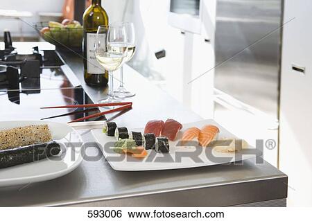 Sushi and white wine on a kitchen bench View Large Photo Image Stock Photograph - Sushi and white wine on a kitchen bench. Fotosearch