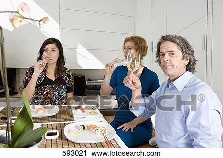 Three friends having dinner together View Large Photo Image Stock Image - Three friends having dinner together. Fotosearch