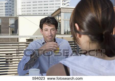 A couple having breakfast together on a rooftop terrace View Large Photo Image Stock Image - A couple having breakfast together on a rooftop terrace. Fotosearch