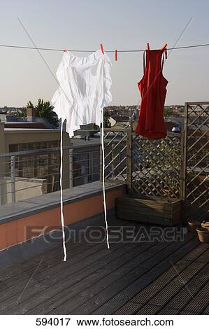 Laundry hanging on a clothesline on a rooftop terrace View Large Photo Image Stock Photo - Laundry hanging on a clothesline on a rooftop terrace. Fotosearch