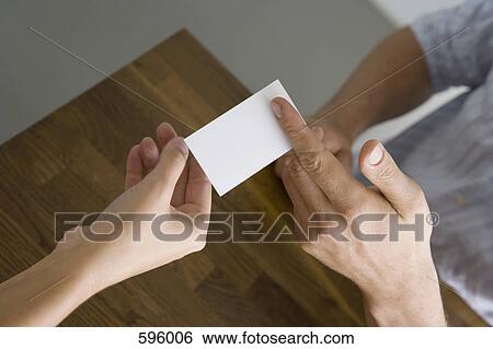 A man and a woman exchanging a business card View Large Photo Image Stock Photograph - A man and a woman exchanging a business card. Fotosearch