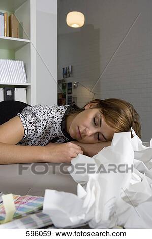 Stock Photo - A Woman asleep at her desk. Fotosearch