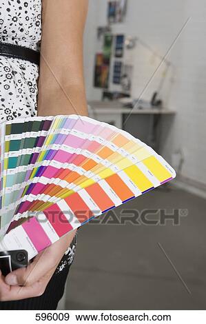A woman holding a color swatch View Large Photo Image Stock Photo - A woman holding a color swatch. Fotosearch
