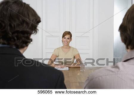 A woman meeting with two men in a board room View Large Photo Image Stock Photography - A woman meeting with two men in a board room. Fotosearch