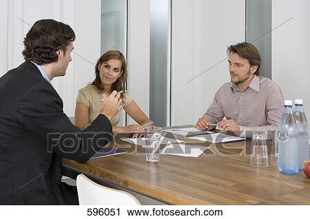 Three people in a business meeting View Large Photo Image Stock Image - Three people in a business meeting. Fotosearch