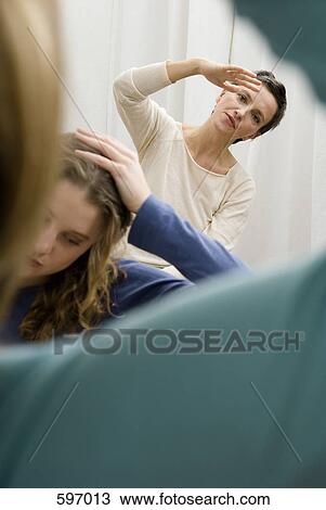 A woman instructing others in stretching exercises View Large Photo Image Stock Image - A woman instructing others in stretching exercises. Fotosearch