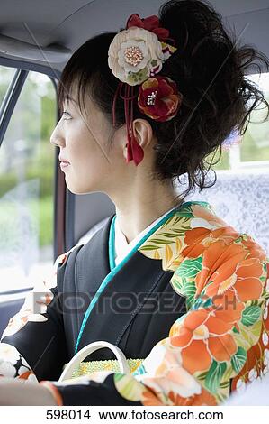 A woman wearing a kimono inside a car View Large Photo Image Picture - A woman wearing a kimono inside a car. Fotosearch