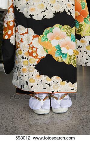 Low section of a woman wearing a kimono and sandals View Large Photo Image Stock Image - Low section of a woman wearing a kimono and sandals. Fotosearch