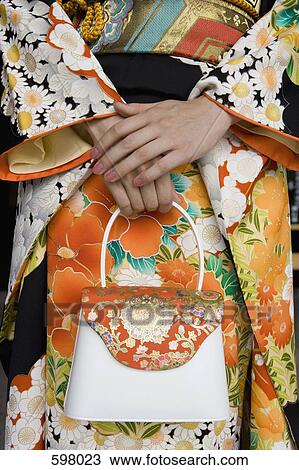 Stock Image - Midsection of a woman wearing a kimono. Fotosearch