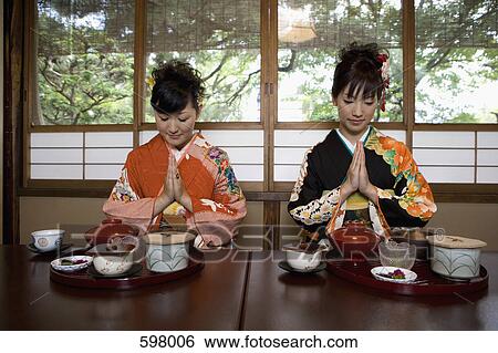 Two woman wearing kimonos in a restaurant View Large Photo Image Stock Photograph - Two woman wearing kimonos in a restaurant. Fotosearch