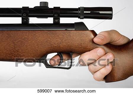A hand holding a gun View Large Photo Image Stock Photo - A hand holding a gun. Fotosearch