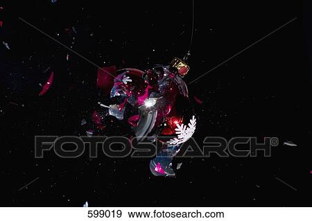 Stock Photo - An exploding Christmas bauble. Fotosearch