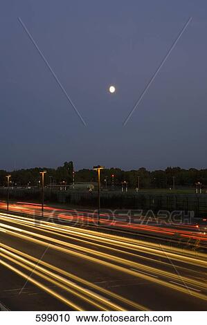 Traffic driving along a motorway at night View Large Photo Image Stock Image - Traffic driving along a motorway at night. Fotosearch