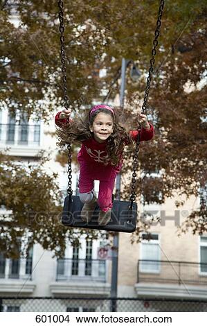 Picture - A girl on a swing. Fotosearch