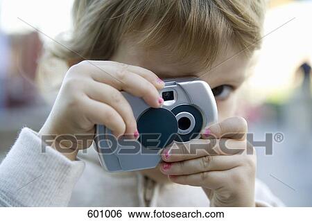 A young girl taking a photograph View Large Photo Image Stock Photograph - A young girl taking a photograph. Fotosearch