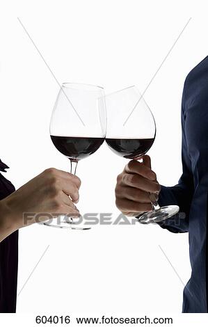 A heterosexual couple toasting wine glasses View Large Photo Image Stock Photograph - A heterosexual couple toasting wine glasses. Fotosearch