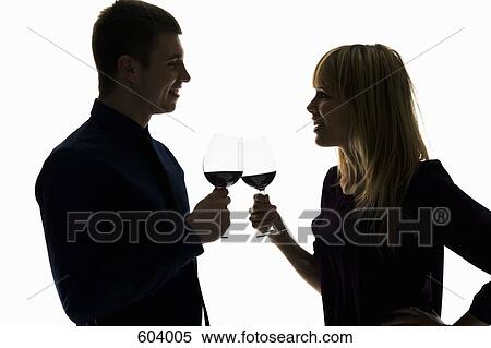 Stock Photography - A heterosexual couple toasting wine glasses. Fotosearch