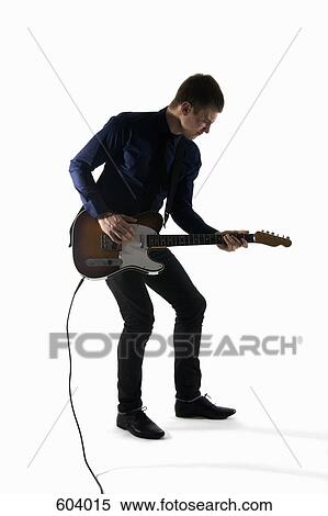 Stock Photography - Studio shot of a man playing an electric guitar. Fotosearch