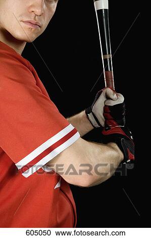 Stock Image - A baseball player holding a baseball bat. Fotosearch