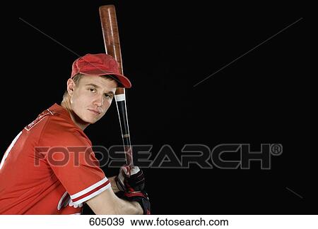 A baseball player holding a baseball bat View Large Photo Image Stock Photo - A baseball player holding a baseball bat. Fotosearch