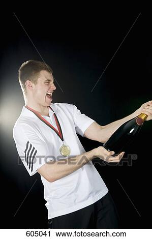 A sportsperson celebrating with champagne View Large Photo Image Stock Image - A sportsperson celebrating with champagne. Fotosearch