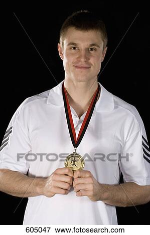 A sportsperson wearing a gold medal View Large Photo Image Stock Photo - A sportsperson wearing a gold medal. Fotosearch